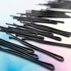 Conair pins beside ruler showing 2 inch length, clear size reference