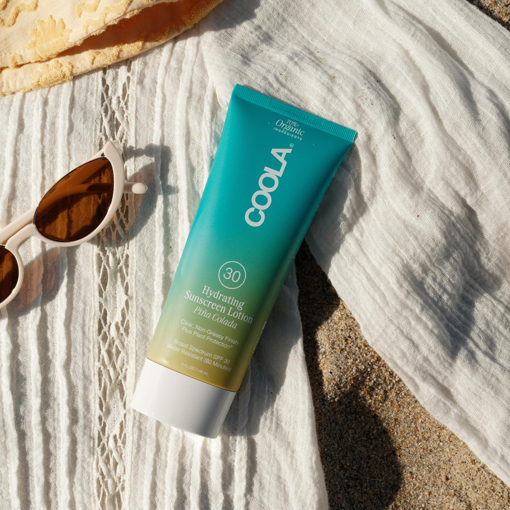 COOLA sunscreen in a beach setting illustrating outdoor-ready, active protection