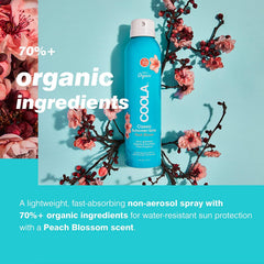 COOLA bottle next to hand for size comparison and travel convenience