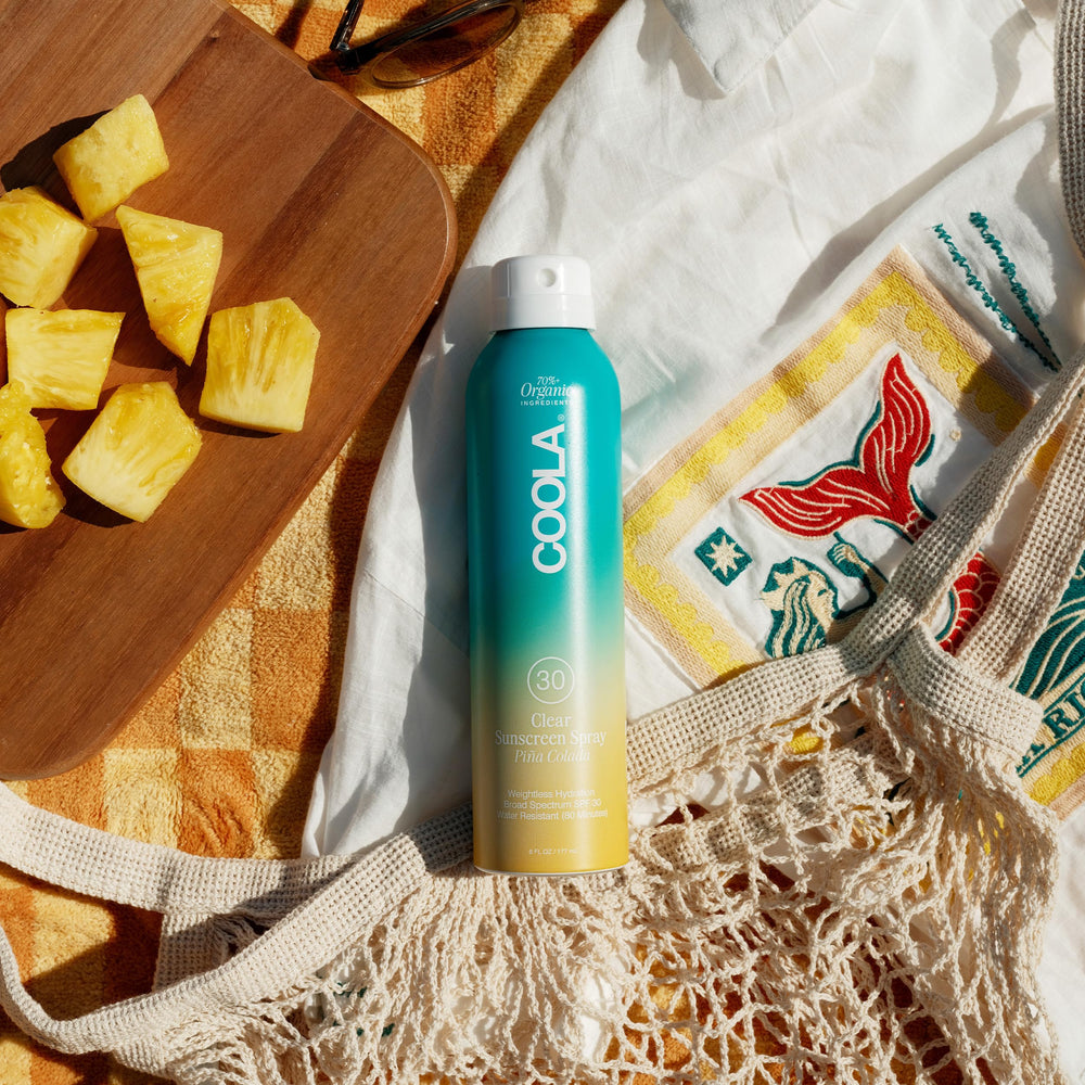 COOLA sheer spray on skin illustrating fast absorption and no greasiness