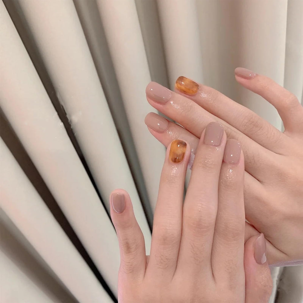 COSMOO polish swatch on skin showing true light brown tone and opacity