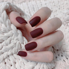 COSMOO painted model hand demonstrating rich wine red matte nails