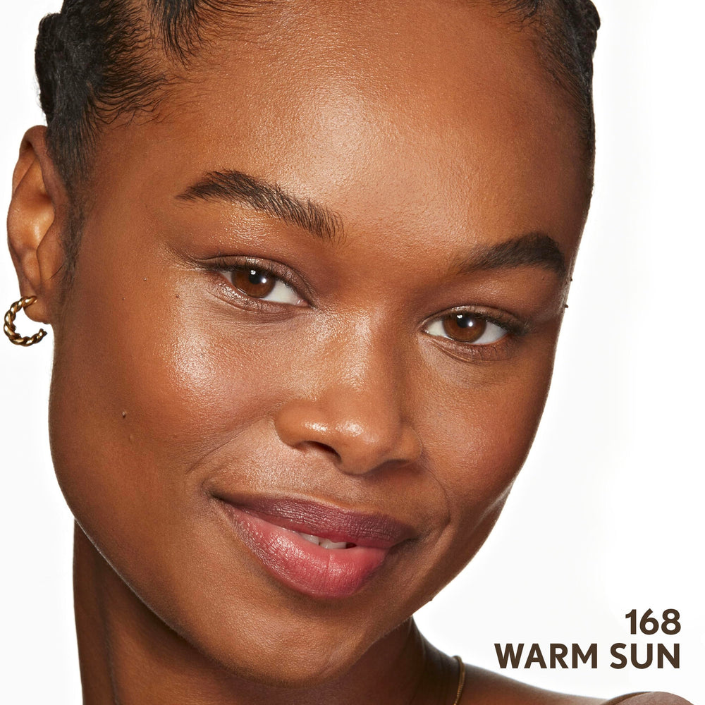 COVERGIRL model wearing foundation outdoors showing everyday dewy finish and comfort