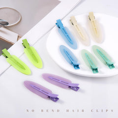 Cptots clip securing bangs and bun in use for non-slip hold during styling