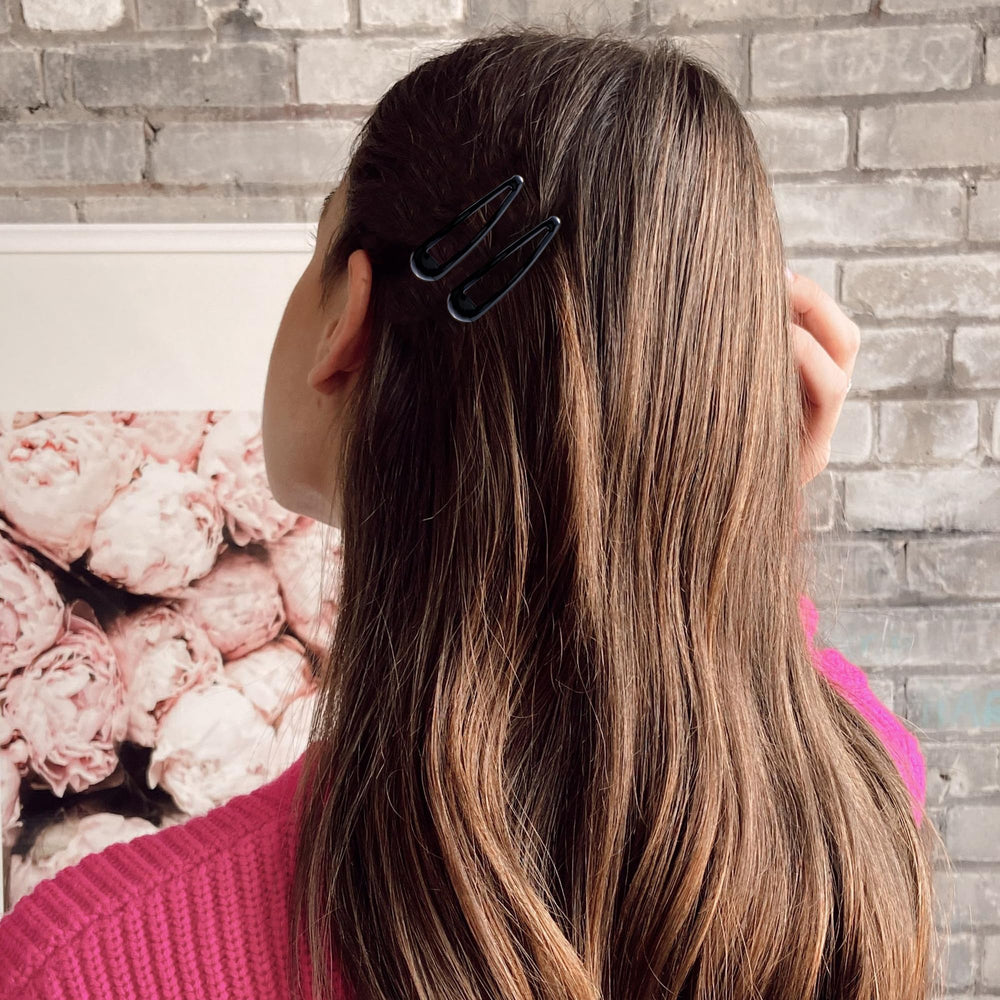 Cptots clip worn in hair securing side bangs for a neat everyday look