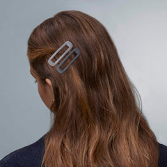 Cptots barrette next to ruler showing 1.97 x 0.55 inch size - accurate scale