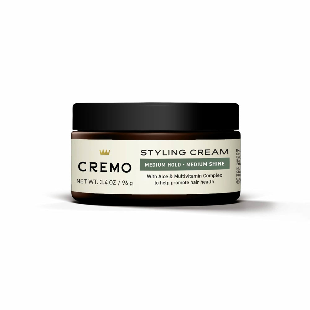 Cremo beside travel toiletries illustrating compact 3.4 oz size for trips
