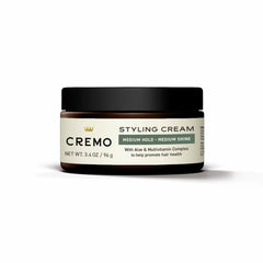 Cremo beside travel toiletries illustrating compact 3.4 oz size for trips