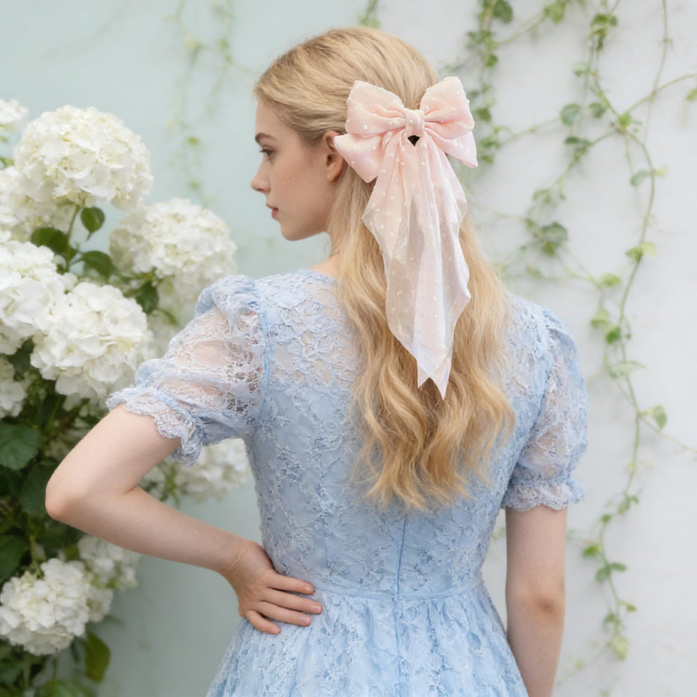 Cupeou bow worn in ponytail demonstrating styling versatility and polish