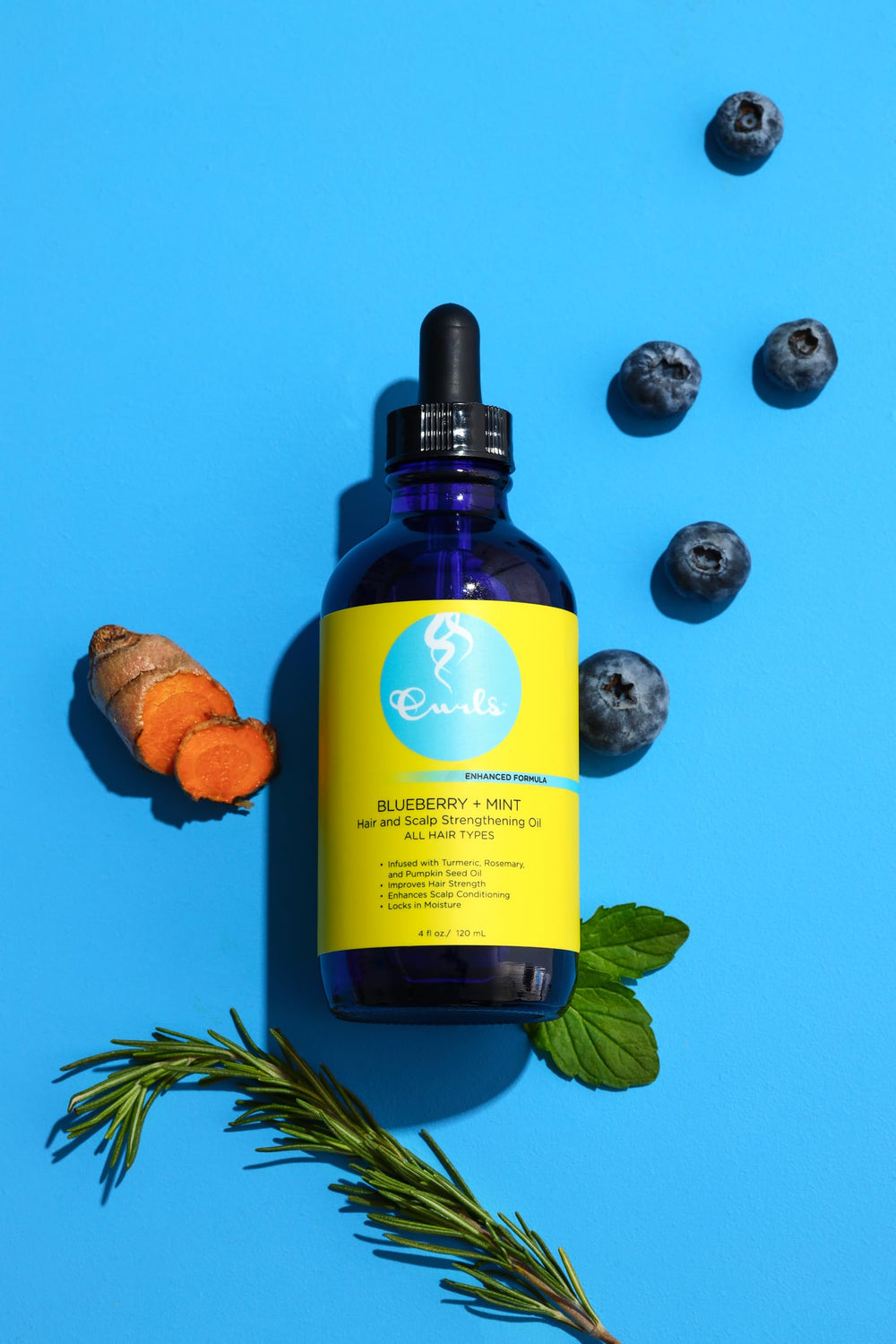 Curls Blueberry Bliss applied to fingertips demonstrating scalp massage benefit