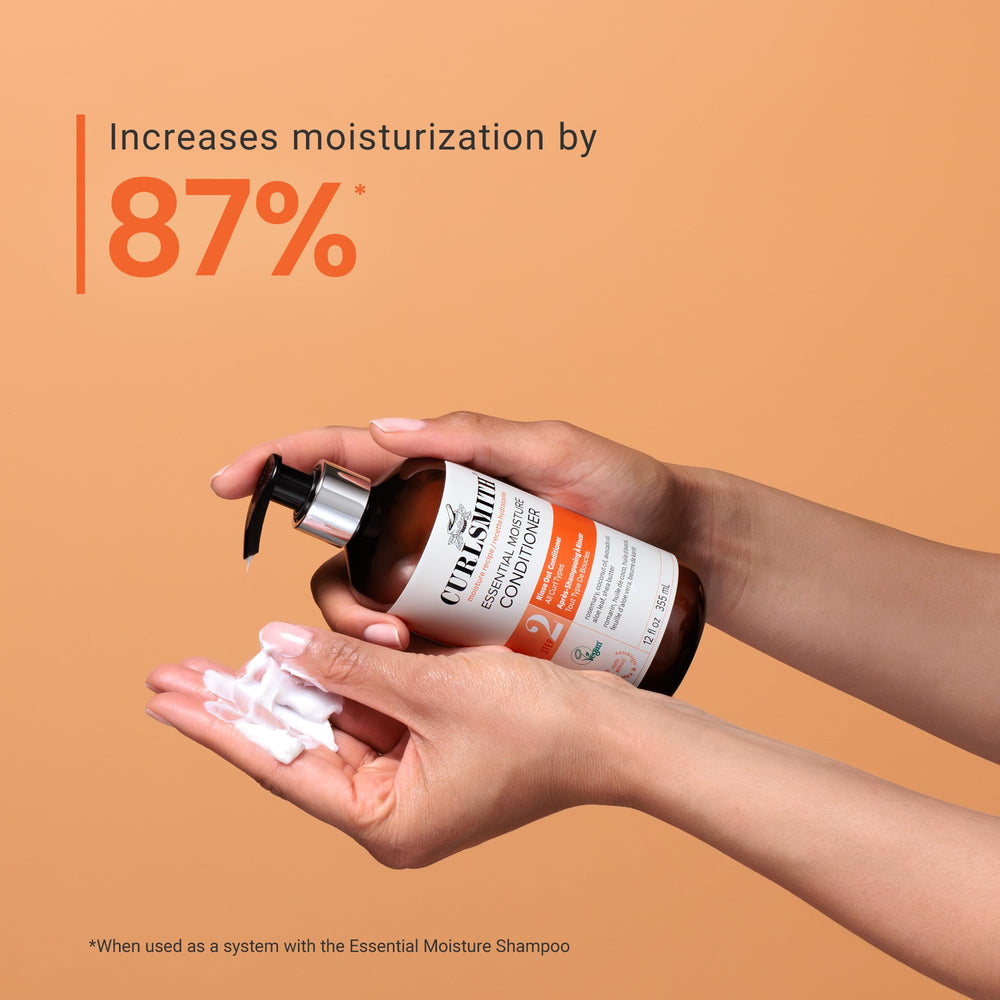 CURLSMITH conditioner being applied to curls for smoother detangling