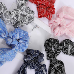 Cutewing scrunchie worn in ponytail demonstrating secure hold without damage