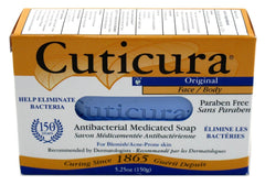 Hand holding Cuticura bar showing 5.25 oz size and easy grip benefit