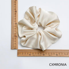 CXMRONIA scrunchie holding a high ponytail showing strong secure hold
