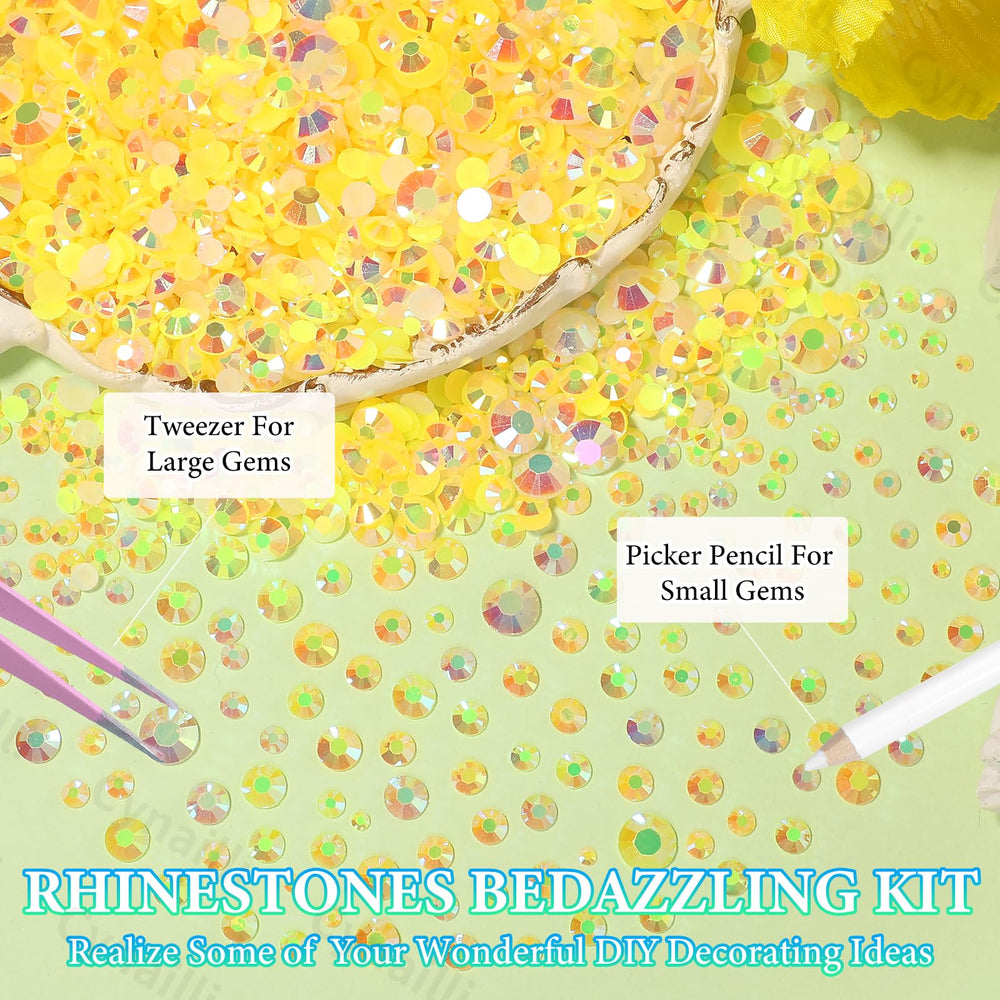 Cynailli tweezers and pickup pen laid beside gems for precise placement and control