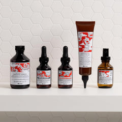 Davines applying shampoo to wet hair showing scalp massage for circulation benefit