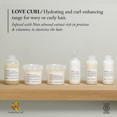 Davines applying cream to damp curls demonstrating easy distribution and definition