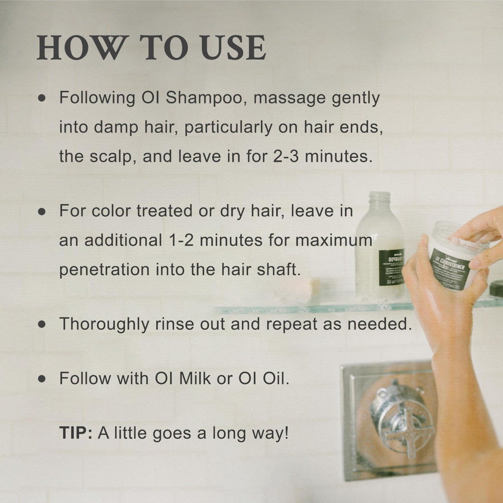 Applying Davines OI conditioner to wet hair for easier detangling and manageability