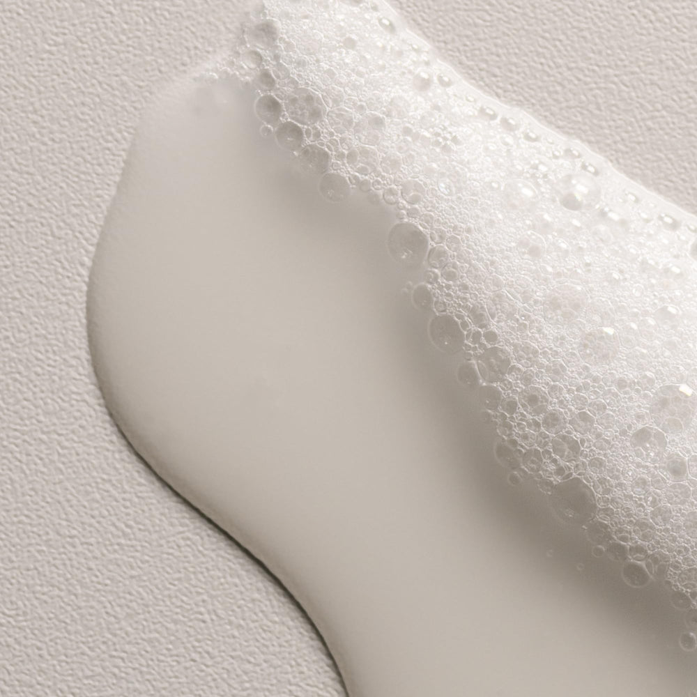 Davines OI Shampoo lather in hands demonstrating gentle cleansing and softness