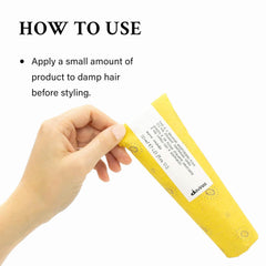Applying Davines fluid to damp hair to prep for blow-drying and smoother styling