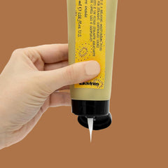 Davines fluid texture on hand highlighting lightweight hydration and shine benefit