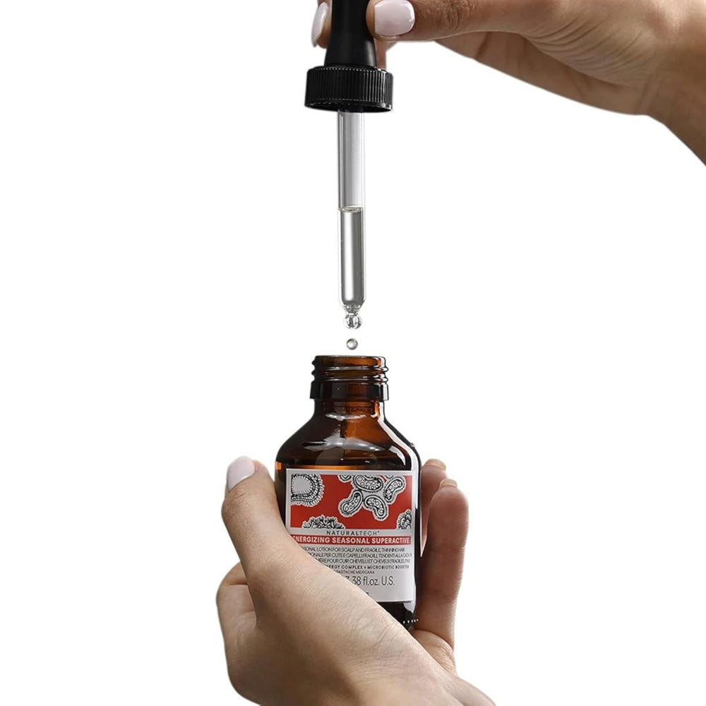 Davines travel-size bottle in hand demonstrating compact convenience