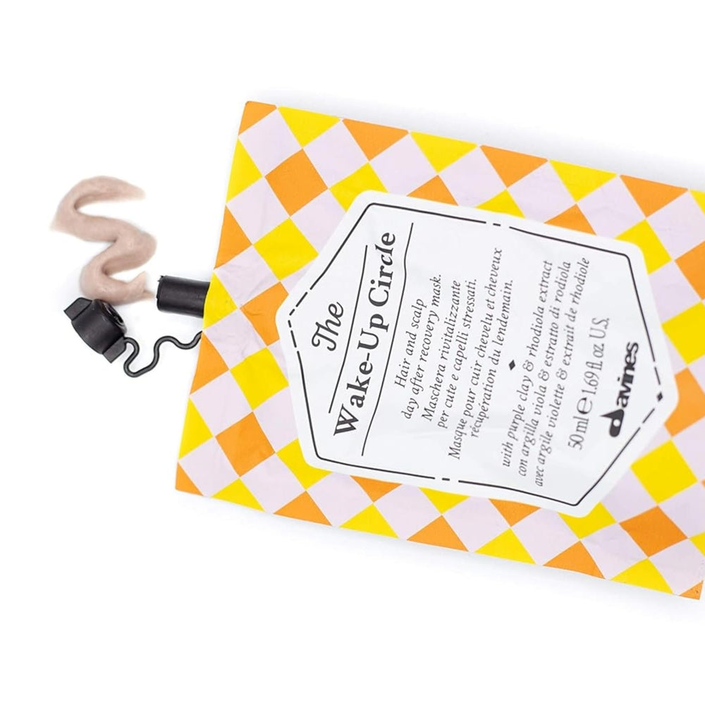 Davines Wake-Up Circle being combed through hair to ensure even coverage and lift