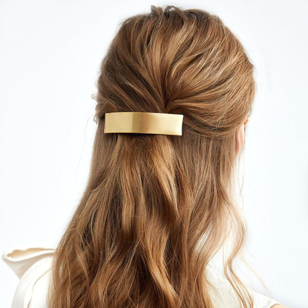 DeD barrettes on a tabletop near jewelry showing stylish accessory pairing