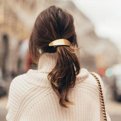DeD barrettes beside a hand to show large size and reliable hold