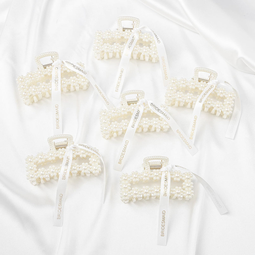 DEEKA clips held in hand to show true scale and practical gift size