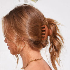 DEEKA clip anchoring a small bun demonstrating secure hold