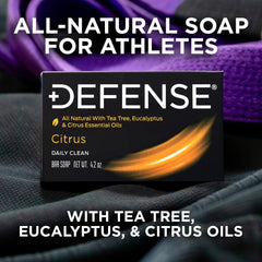 Defense Soap citrus bar in hand showing 4.2 oz scale and portability