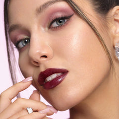 Depuplum applying on lips demonstrating smooth glide and buildable color