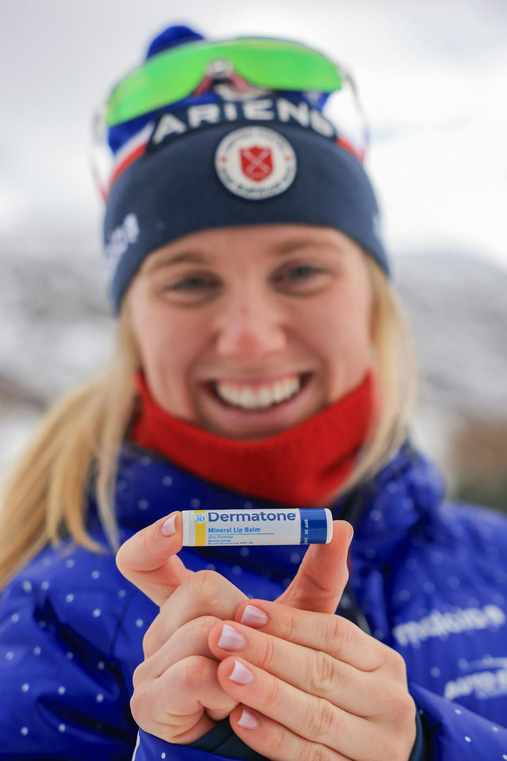 DERMATONE lip balm held in hand showing compact travel-friendly size