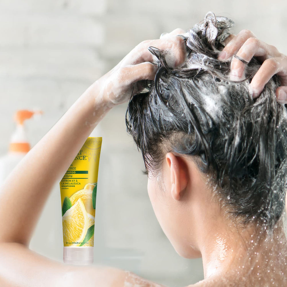 Shampoo bottle staged on bathroom shelf with towel, Desert Essence illustrating everyday cleansing use