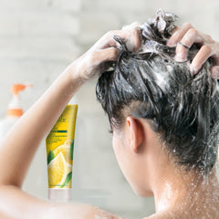 Shampoo bottle staged on bathroom shelf with towel, Desert Essence illustrating everyday cleansing use