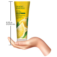 Desert Essence bottle beside common travel items to show 8 oz size and convenient portability