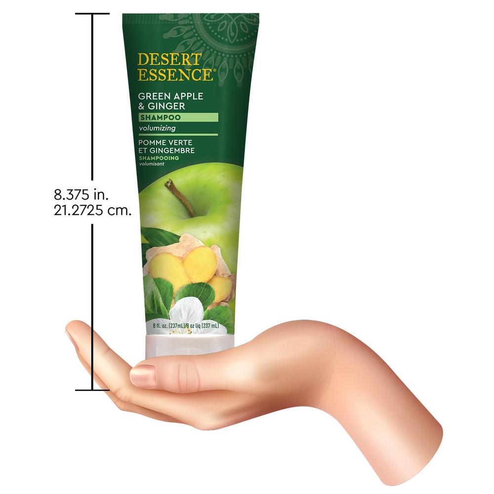 Person holding Desert Essence shampoo to show application and improved manageability