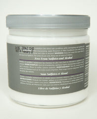 Design Essentials conditioner on hand being applied, soothes scalp and moisturizes