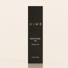 DIME 1 oz bottle next to a coin for scale to show compact travel-friendly size