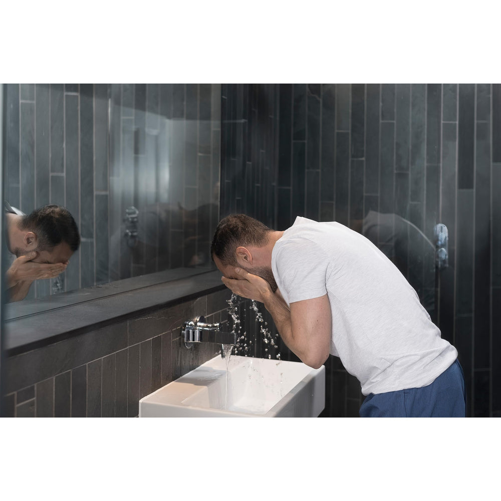 DOVE MEN + CARE bottle in hand showing 5 fl oz scale