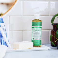 Dr. Bronner's pouring concentrated liquid soap demonstrating controlled dispensing benefit