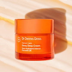 Dr Dennis Gross jar in lifestyle setting showing dewy skin result and radiant finish