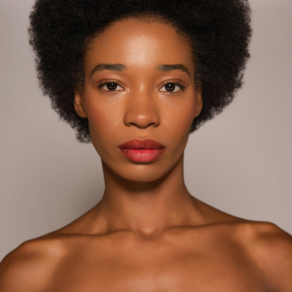 Dr. PAWPAW ORIGINAL BALM blended on cheeks showing subtle flush and easy application