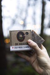 Dr. Squatch soap in hand for size and grip, showing convenient travel-friendly bar