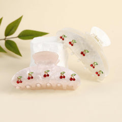 Drealoe cherry clips styled in half-up hair adding cute accent and photo-ready look