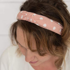 DRESHOW hand holding headband showing scale and lightweight benefit
