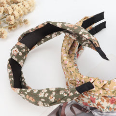 DRESHOW headband next to hand for scale showing compact, lightweight design