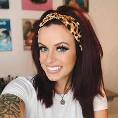 DRESHOW headband by ruler illustrating stretchable length and size