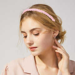 Drnytunk headband held in hand to show scale and flexible, bendable construction